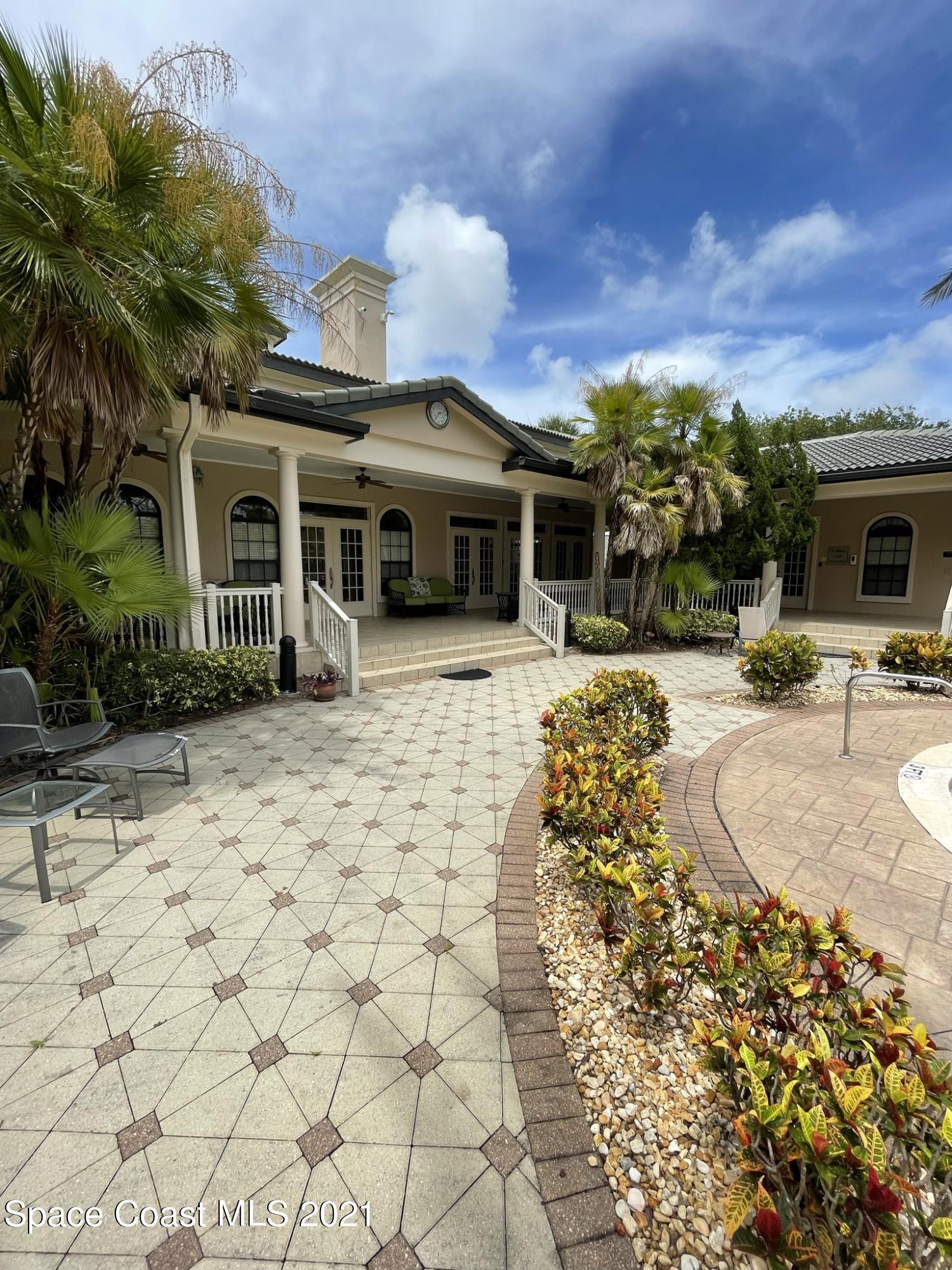 6411 Borasco Drive, Unit 319 Melbourne, FL 32940 - Photo 25 of 27 a front view of a house with garden