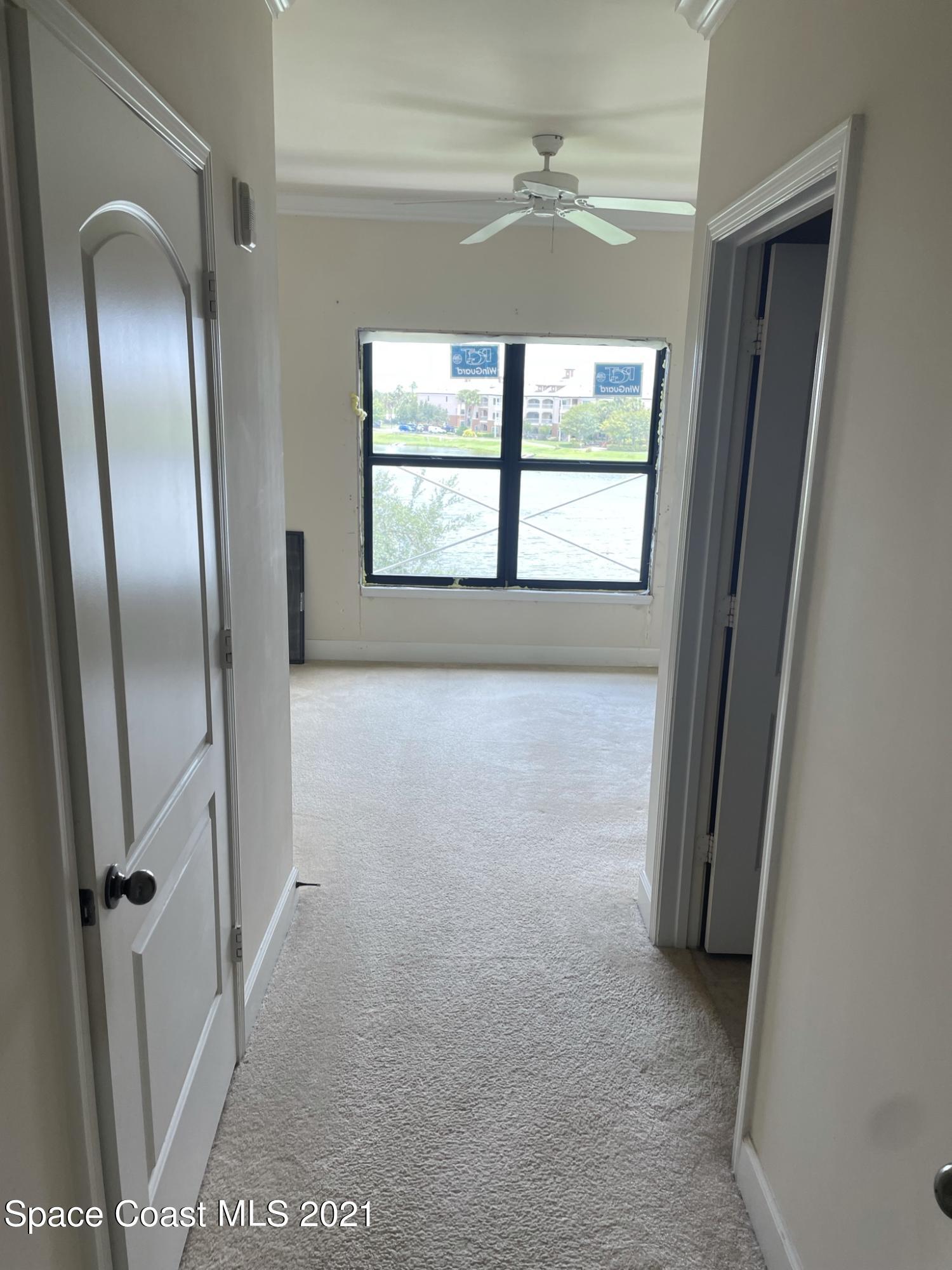 6411 Borasco Drive, Unit 319 Melbourne, FL 32940 - Photo 3 of 27 a view of an empty room with a window