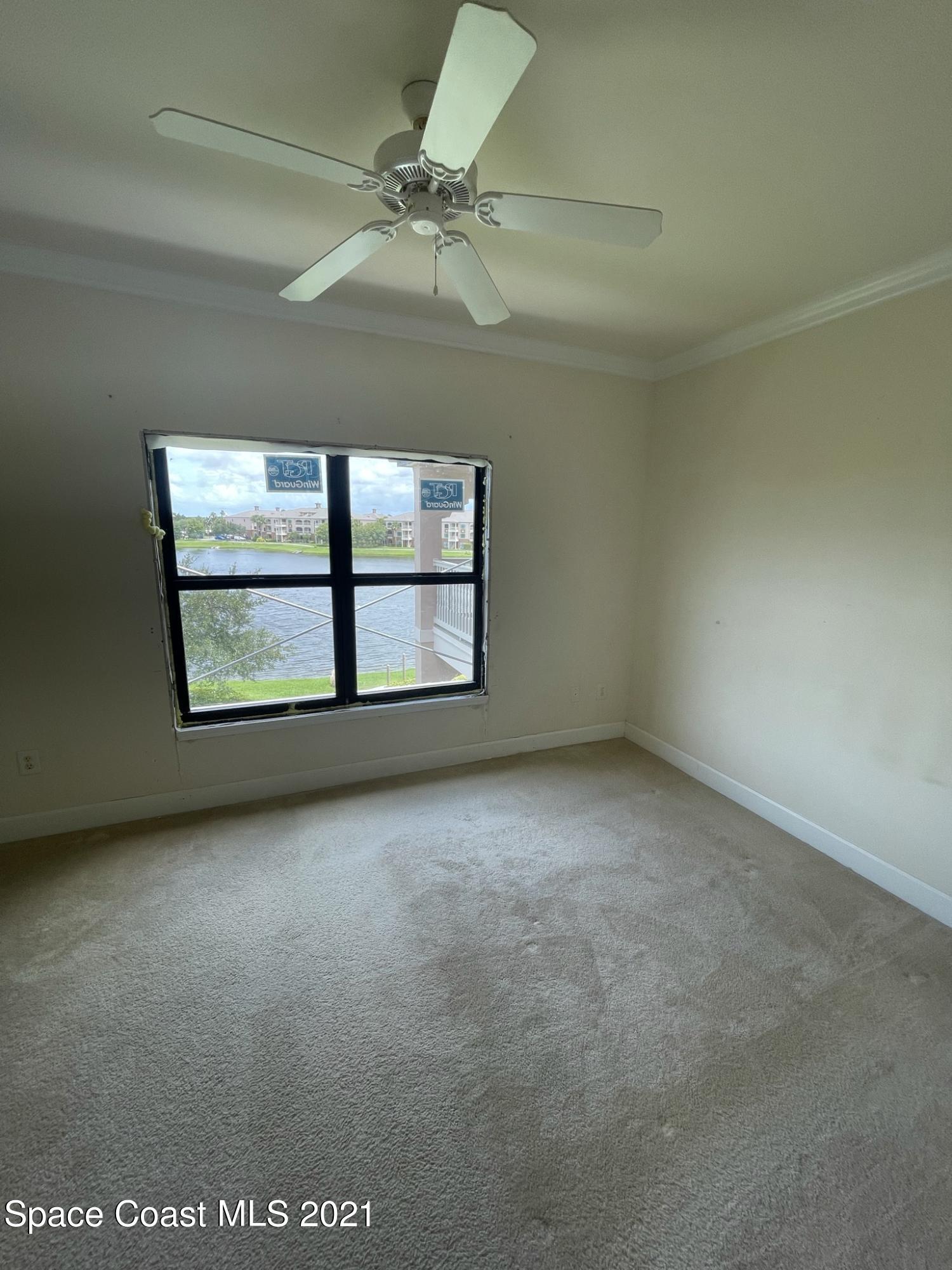 6411 Borasco Drive, Unit 319 Melbourne, FL 32940 - Photo 6 of 27 an empty room with windows