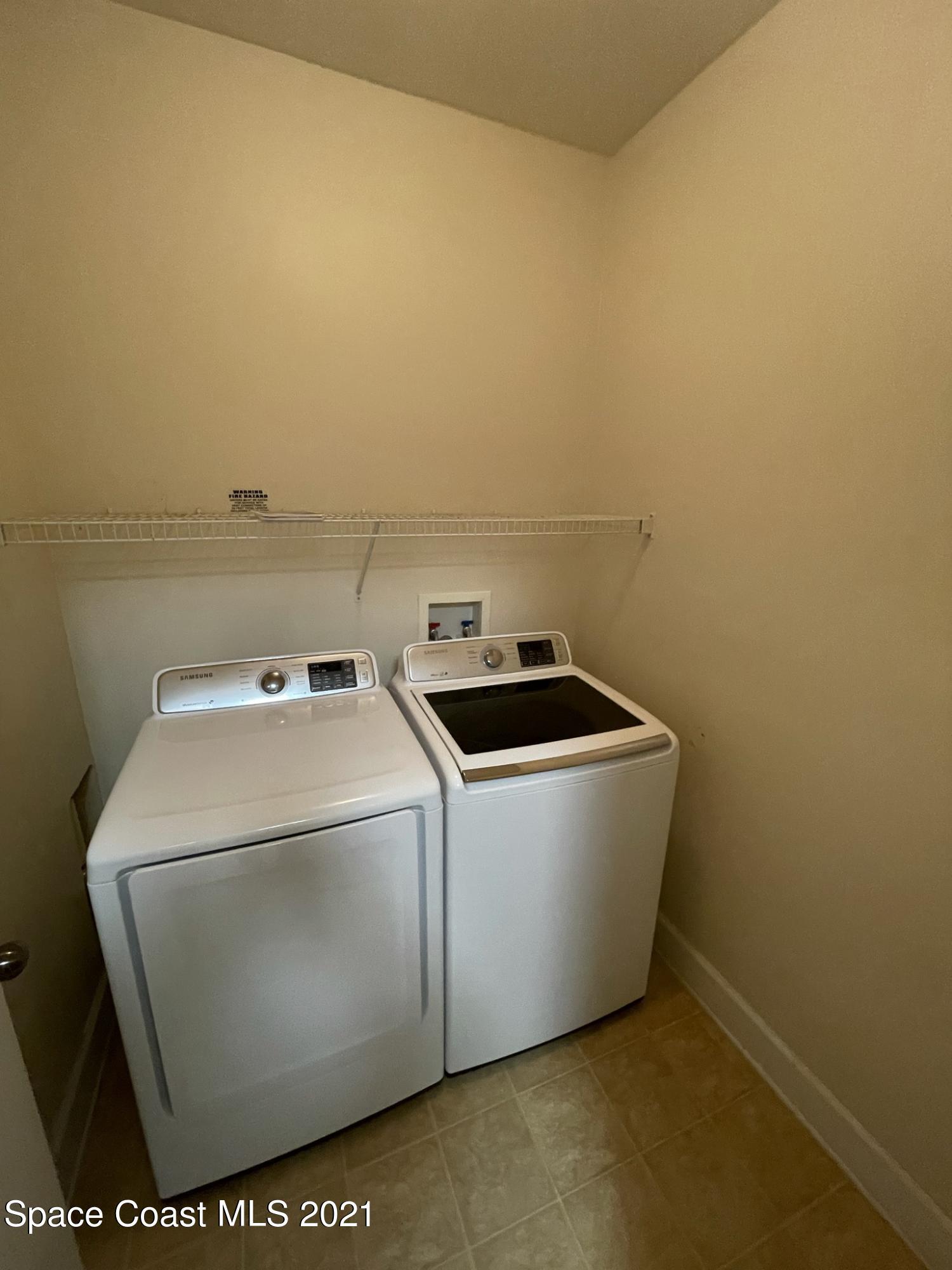6411 Borasco Drive, Unit 319 Melbourne, FL 32940 - Photo 9 of 27 a utility room with dryer and washer