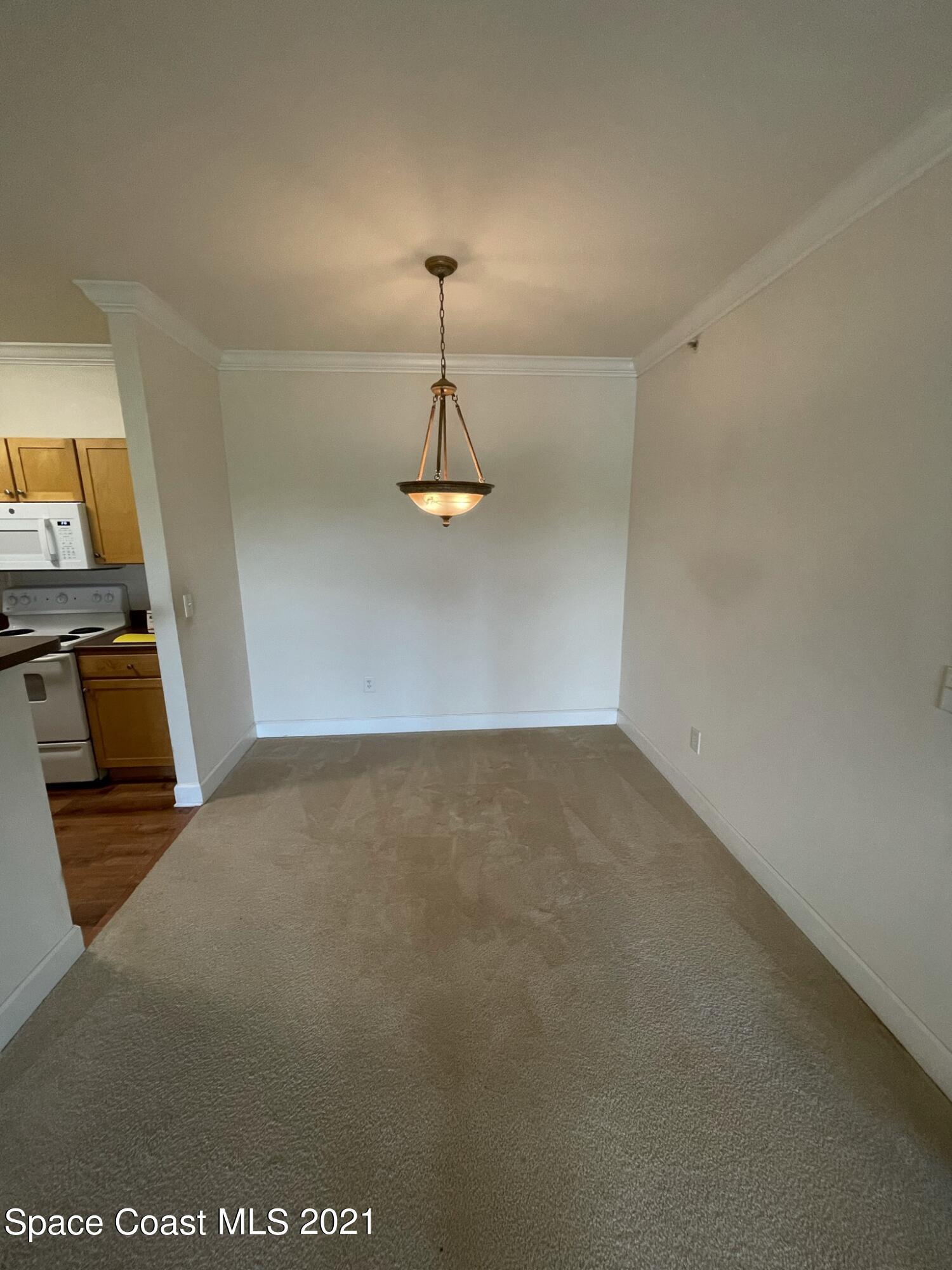 6411 Borasco Drive, Unit 319 Melbourne, FL 32940 - Photo 10 of 27 a view of empty room with wooden floor