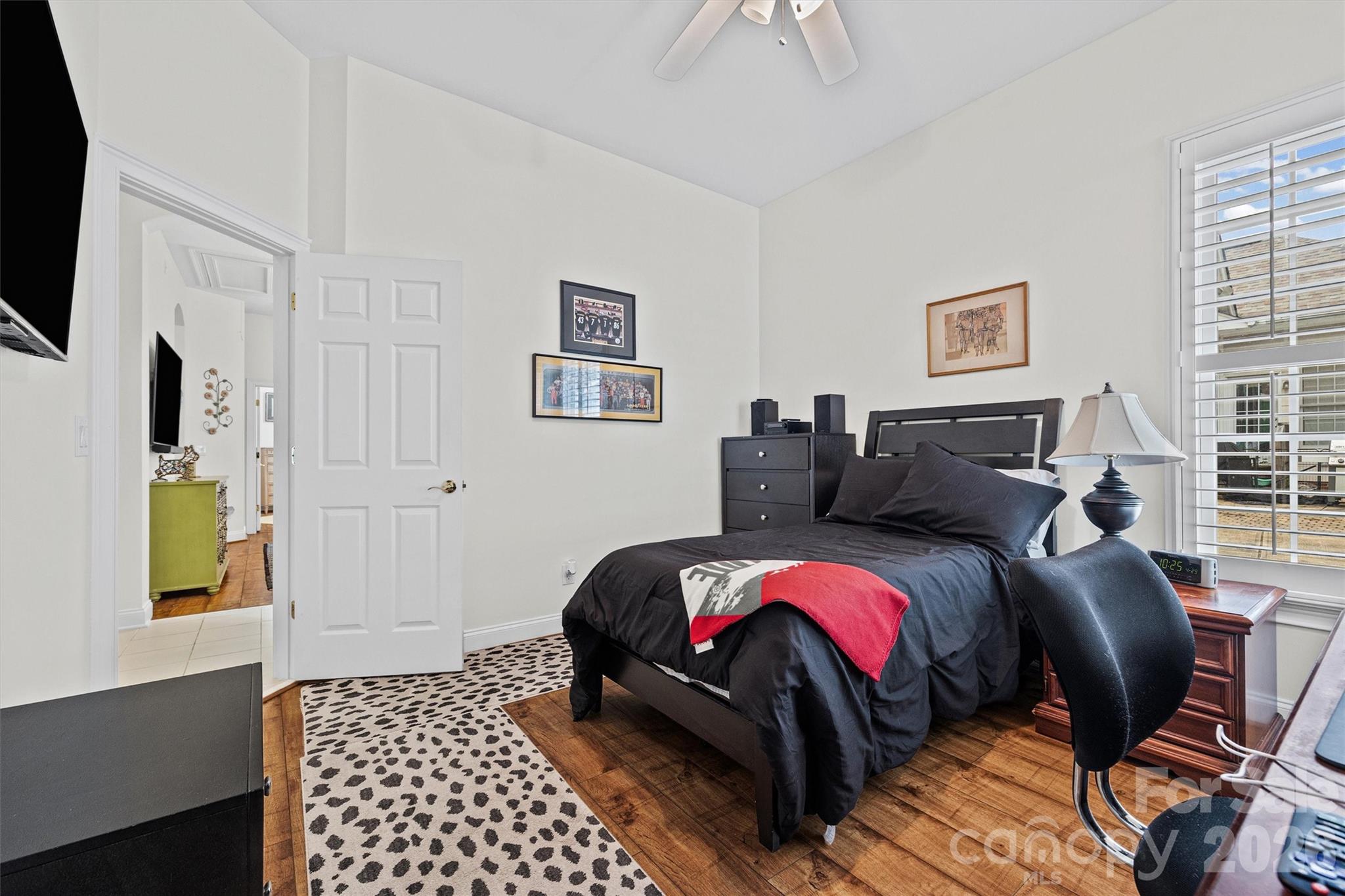 2578 Lower Assembly Drive Fort Mill, SC 29708 - Photo 19 of 28 a bedroom with a bed and wooden floor
