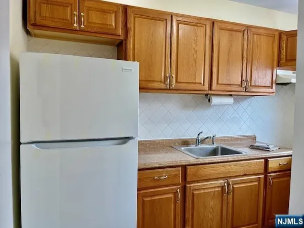 a kitchen with a sink and a refrigerator