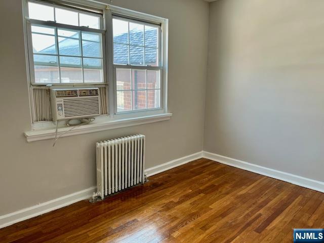 285 Teaneck Road, Unit 285B Ridgefield Park, NJ 07660 - Photo 10 of 12 an empty room with wooden floor and windows