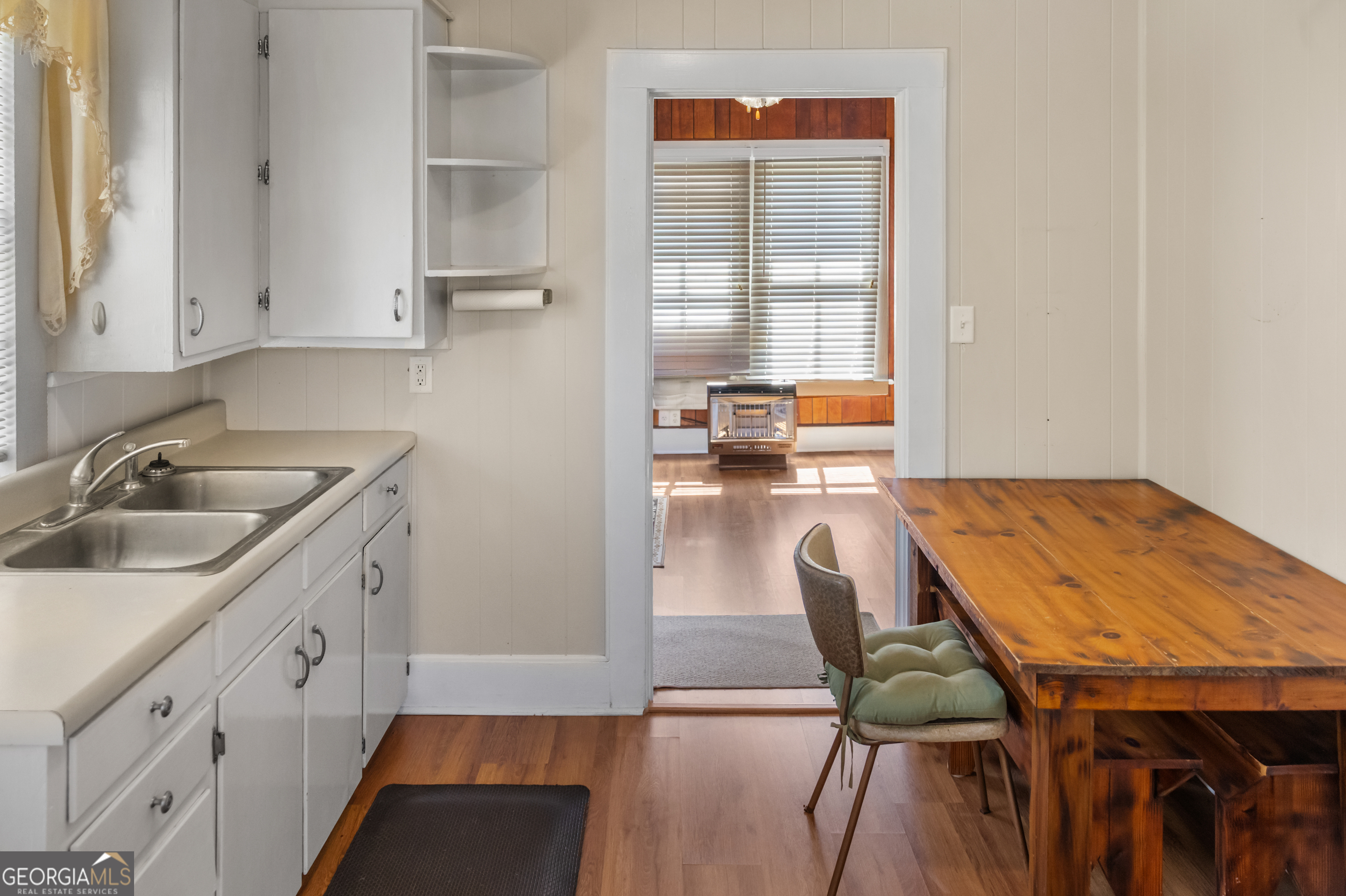 17332 Old River Road North Statesboro, GA 30461 - Photo 17 of 26 a kitchen with a table chairs sink and cabinets