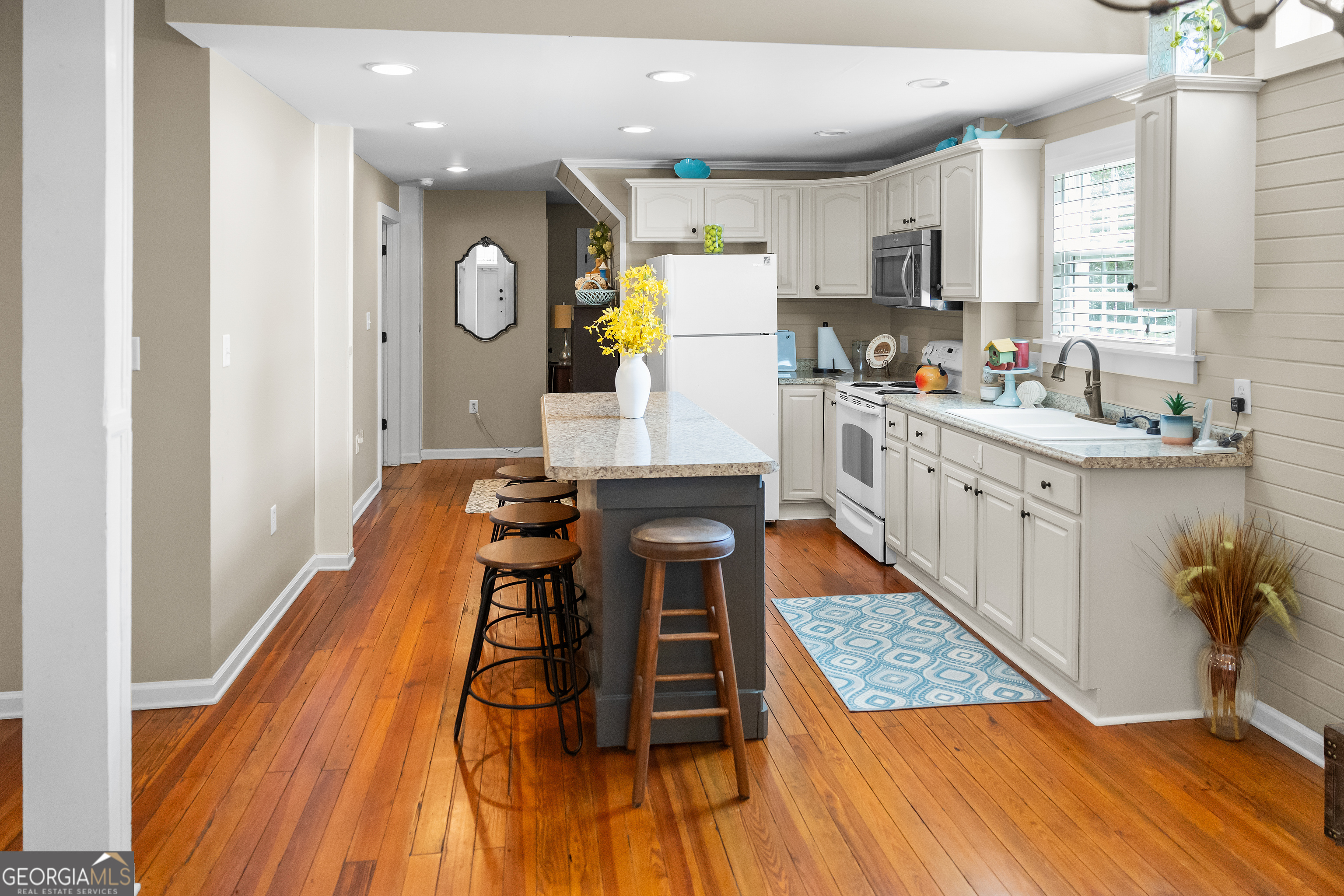 17332 Old River Road North Statesboro, GA 30461 - Photo 6 of 26 a kitchen with a table chairs refrigerator and microwave