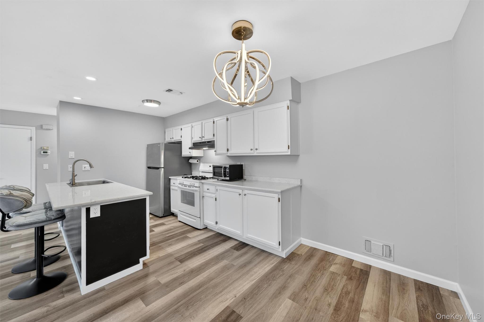 43 The Rise Warwick, NY 10990 - Photo 21 of 49 a kitchen with cabinets wooden floor and stainless steel appliances