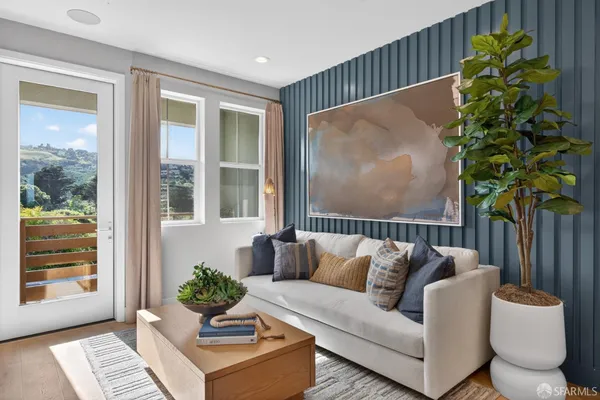 a living room with furniture and a potted plant