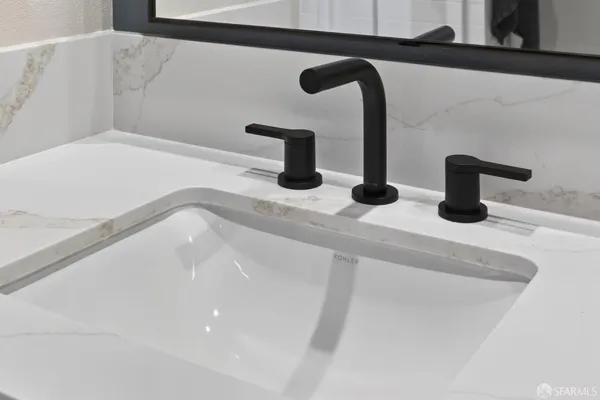 a bathroom with a granite countertop sink mirror and shower