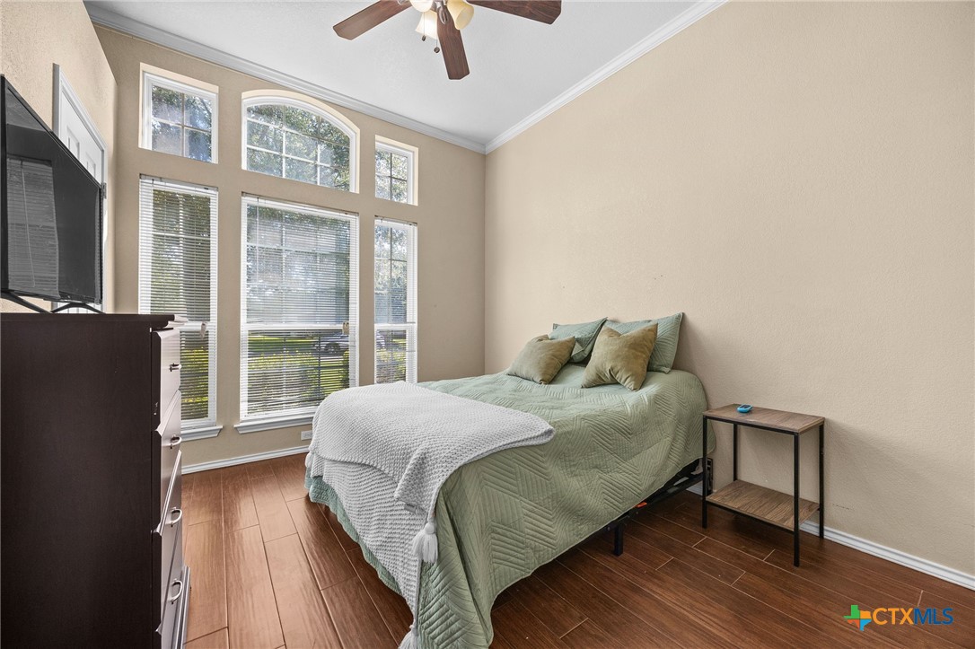910 Neuberry Cliffe Temple, TX 76502 - Photo 19 of 32 a bedroom with a bed and a large window