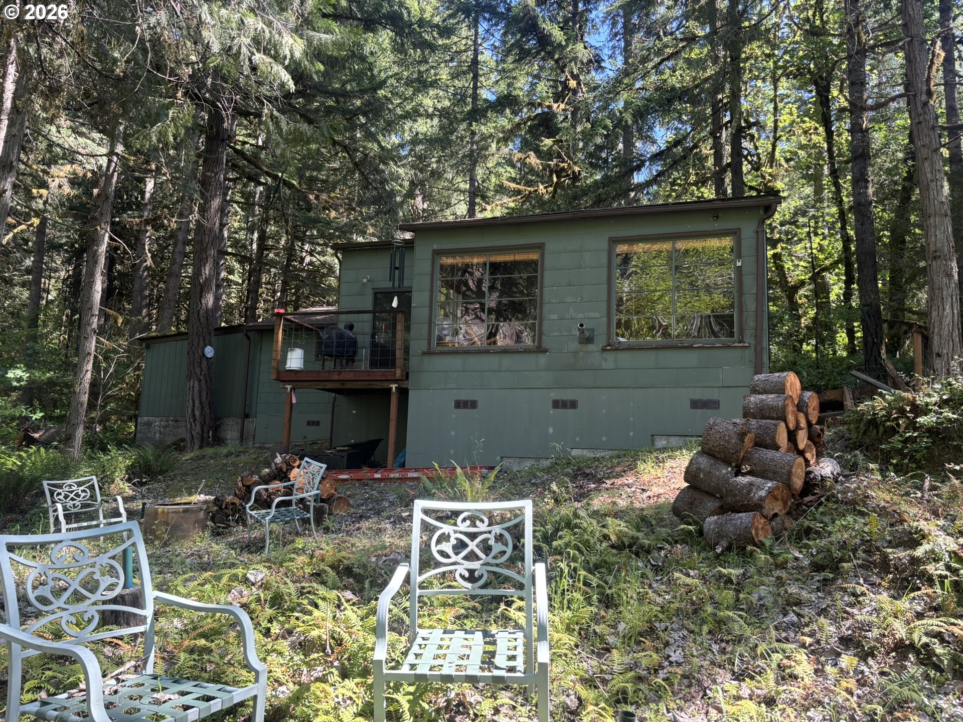 a view of backyard of the house with outdoor seating