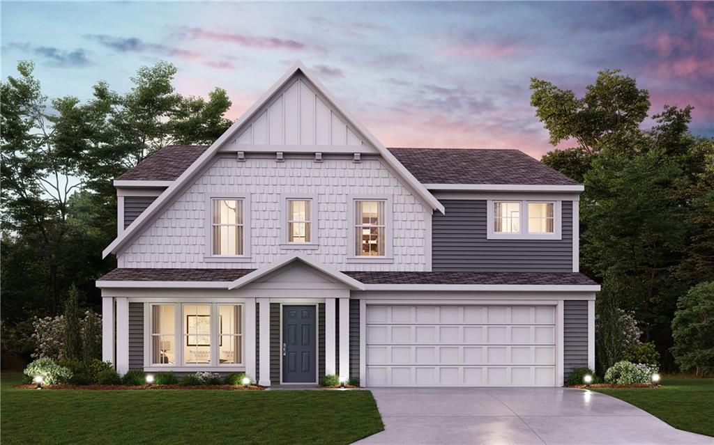 a front view of a house with a garden and plants