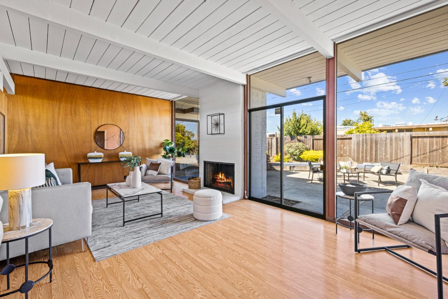 653 Edna Way San Mateo, CA 94402 - Photo 10 of 41 a living room with furniture a fireplace and a floor to ceiling window