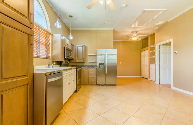 a kitchen with stainless steel appliances a refrigerator and a stove
