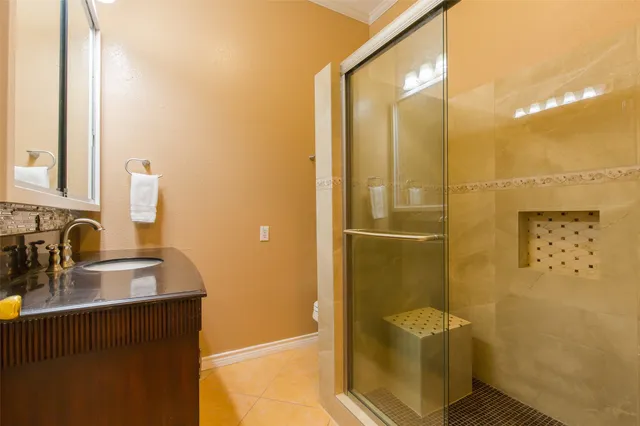 a bathroom with a sink a mirror and a shower