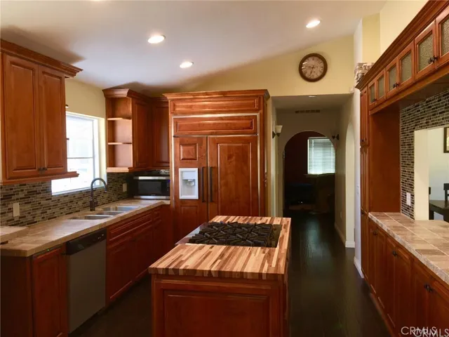 a large kitchen with stainless steel appliances granite countertop a sink and a stove