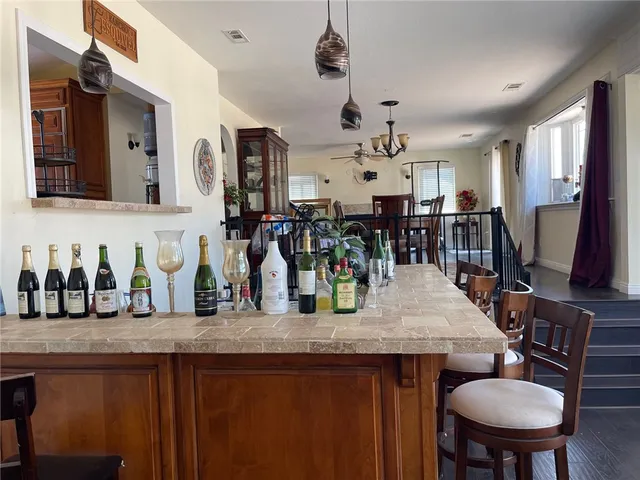 a kitchen with stainless steel appliances granite countertop a sink and a table