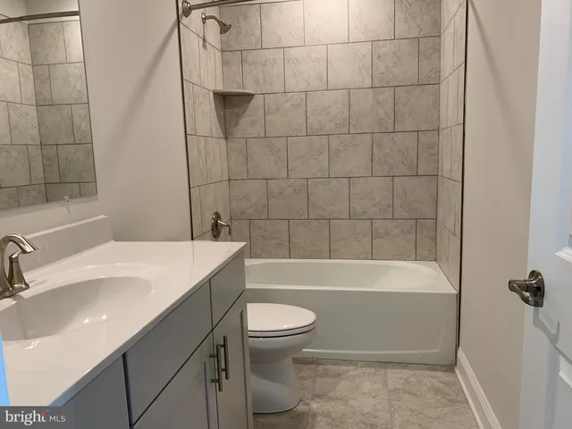 a bathroom with a sink a toilet and bathtub