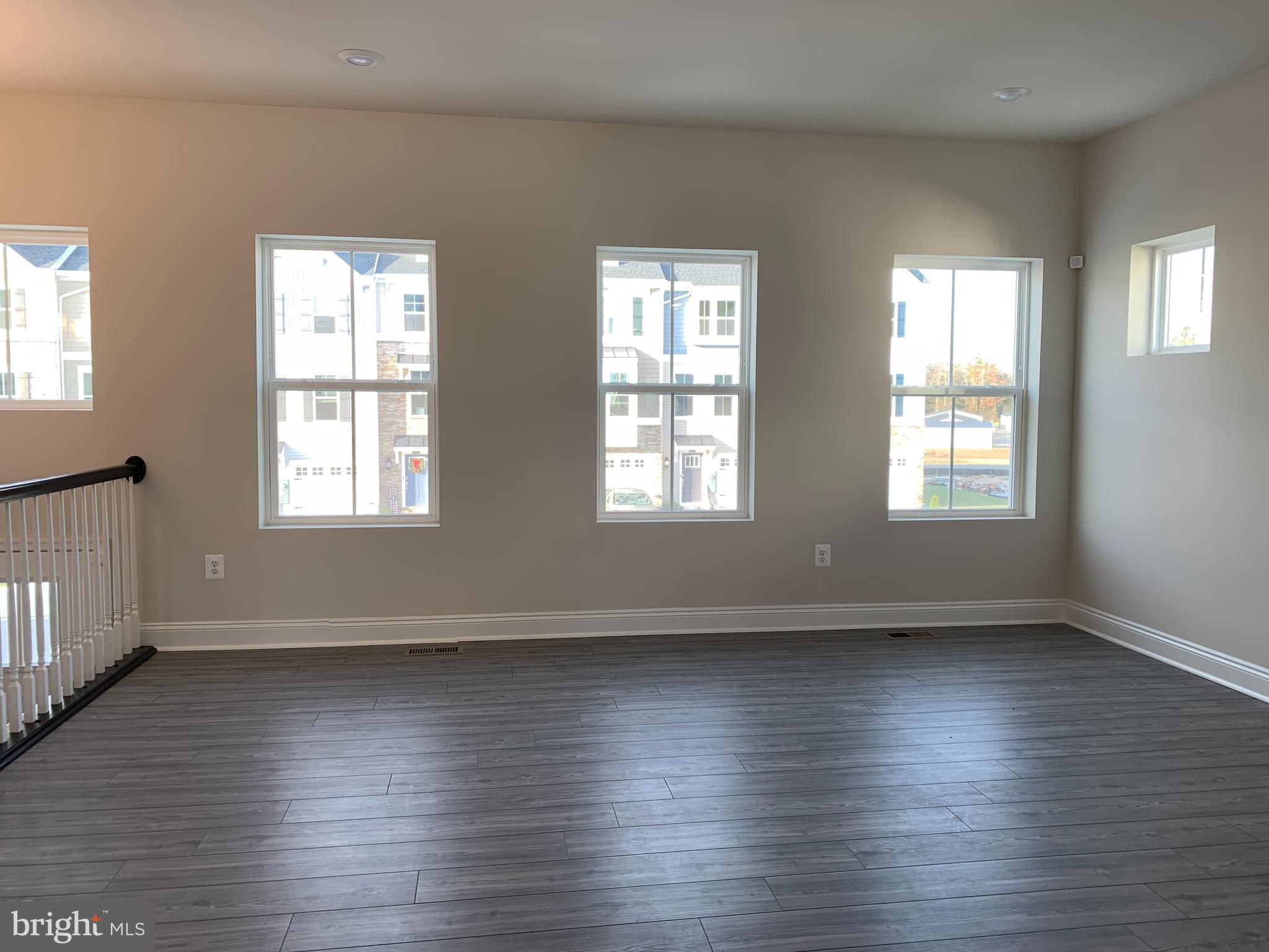 35318 Wright Way Millsboro, DE 19966 - Photo 4 of 28 an empty room with wooden floor and windows