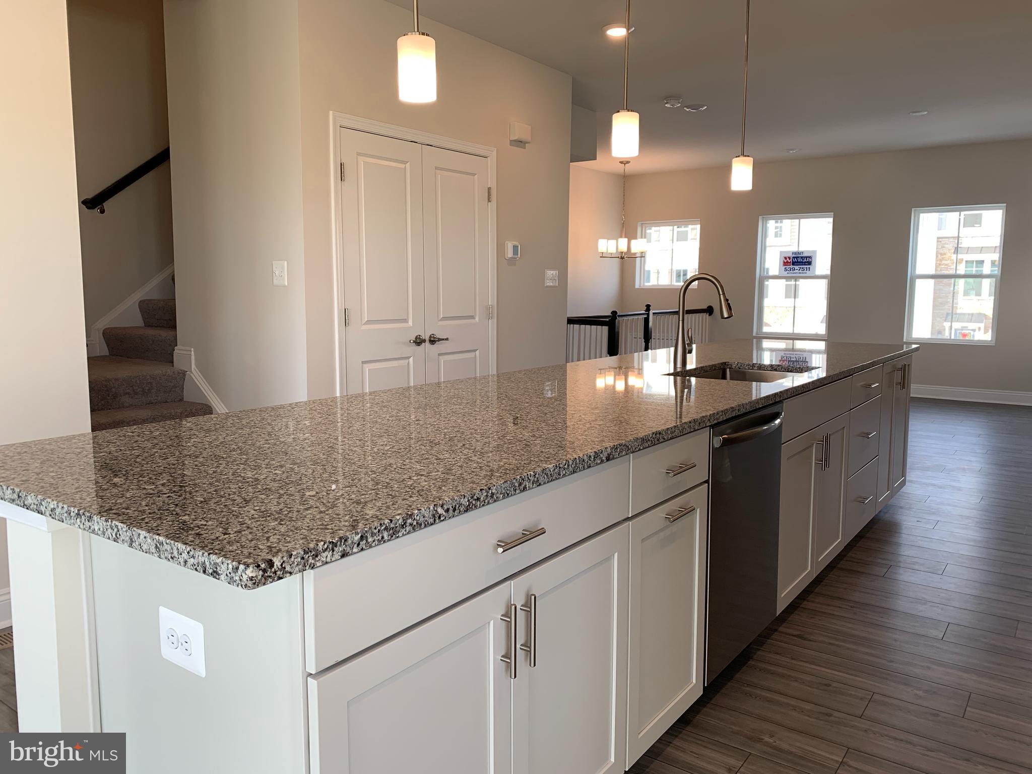 35318 Wright Way Millsboro, DE 19966 - Photo 8 of 28 a kitchen with kitchen island granite countertop a sink and counter space