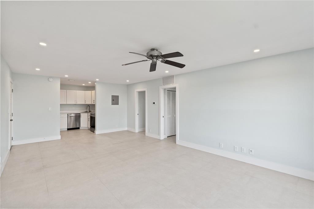 1770 East Las Olas Boulevard, Unit 505 Fort Lauderdale, FL 33301 - Photo 19 of 33 an empty room with chandelier fan and windows