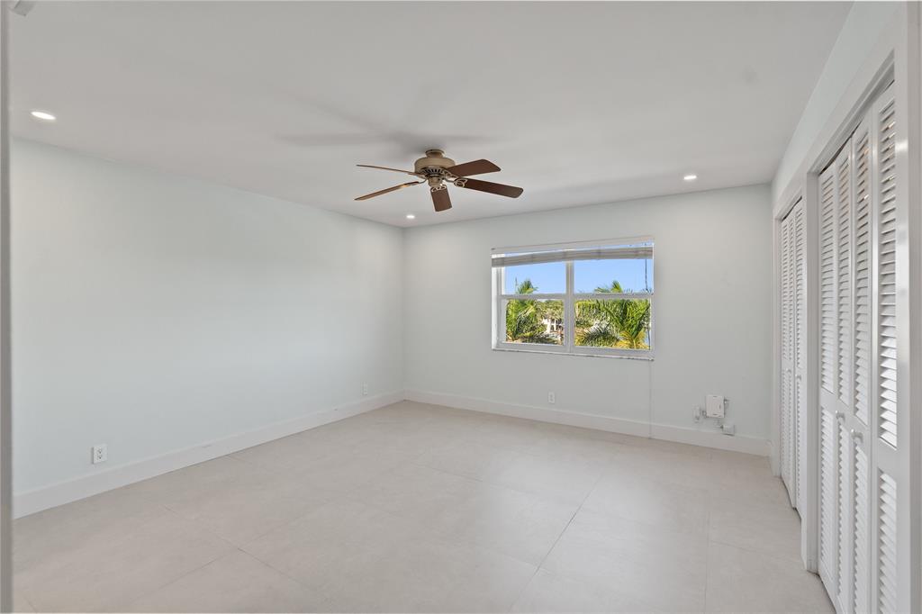 1770 East Las Olas Boulevard, Unit 505 Fort Lauderdale, FL 33301 - Photo 21 of 33 en empty room with windows and ceiling fan view