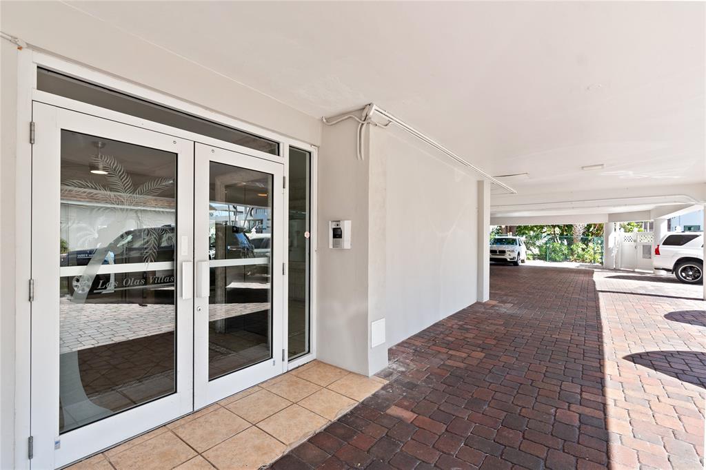 1770 East Las Olas Boulevard, Unit 505 Fort Lauderdale, FL 33301 - Photo 28 of 33 a view of a hallway with two windows and plants