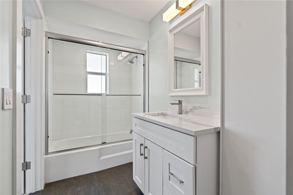 1770 East Las Olas Boulevard, Unit 505 Fort Lauderdale, FL 33301 - Photo 5 of 33 a bathroom with a granite countertop sink mirror and a bathtub