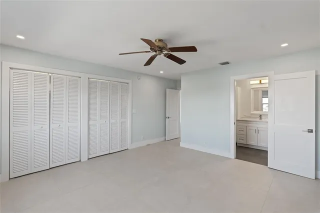 wooden floor in an empty room and a ceiling fan window