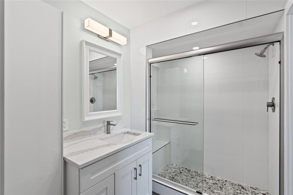 1770 East Las Olas Boulevard, Unit 505 Fort Lauderdale, FL 33301 - Photo 7 of 33 a bathroom with a granite countertop sink toilet and shower