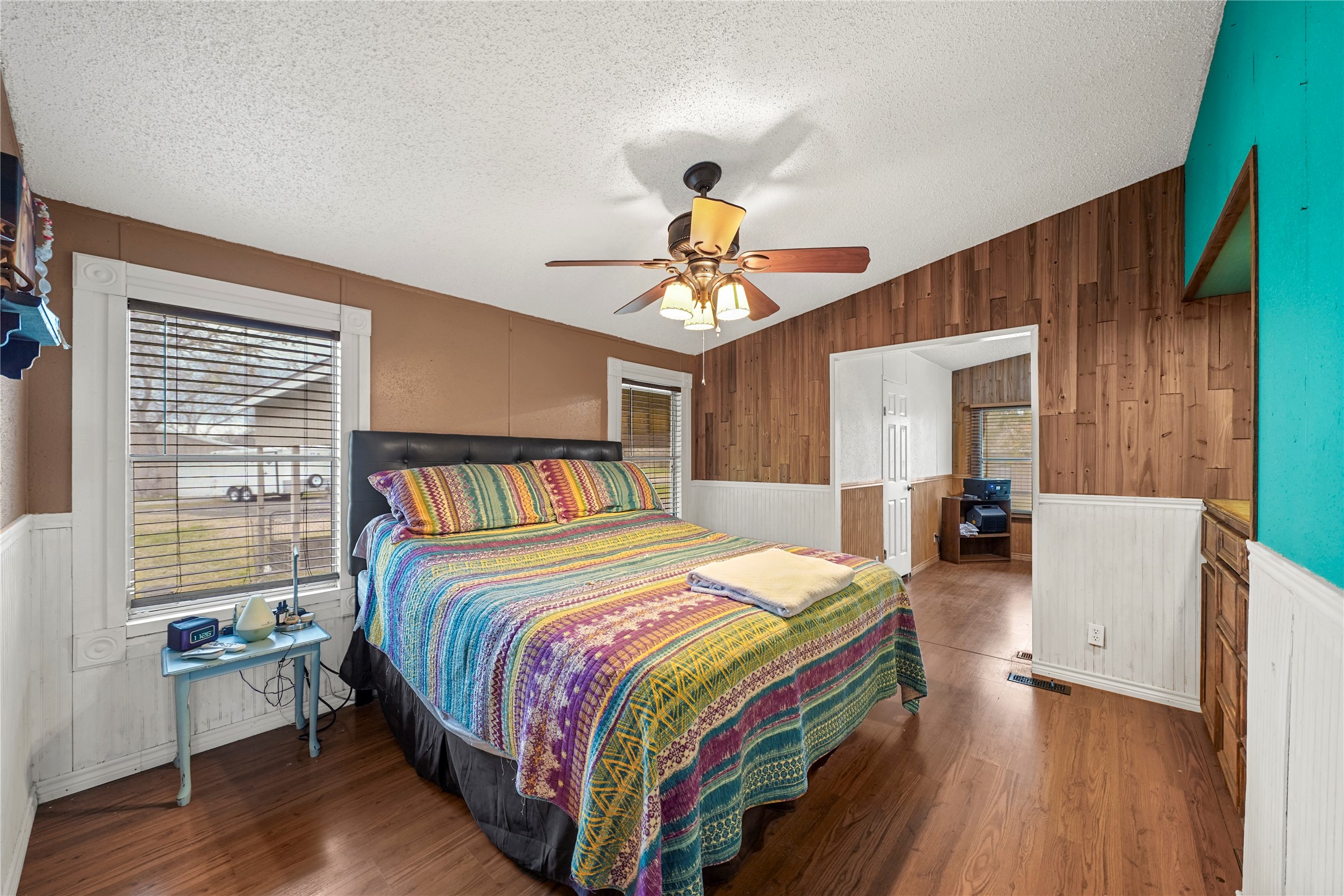 19645 Nordt Road Damon, TX 77430 - Photo 15 of 50 a bedroom with a bed and a chandelier