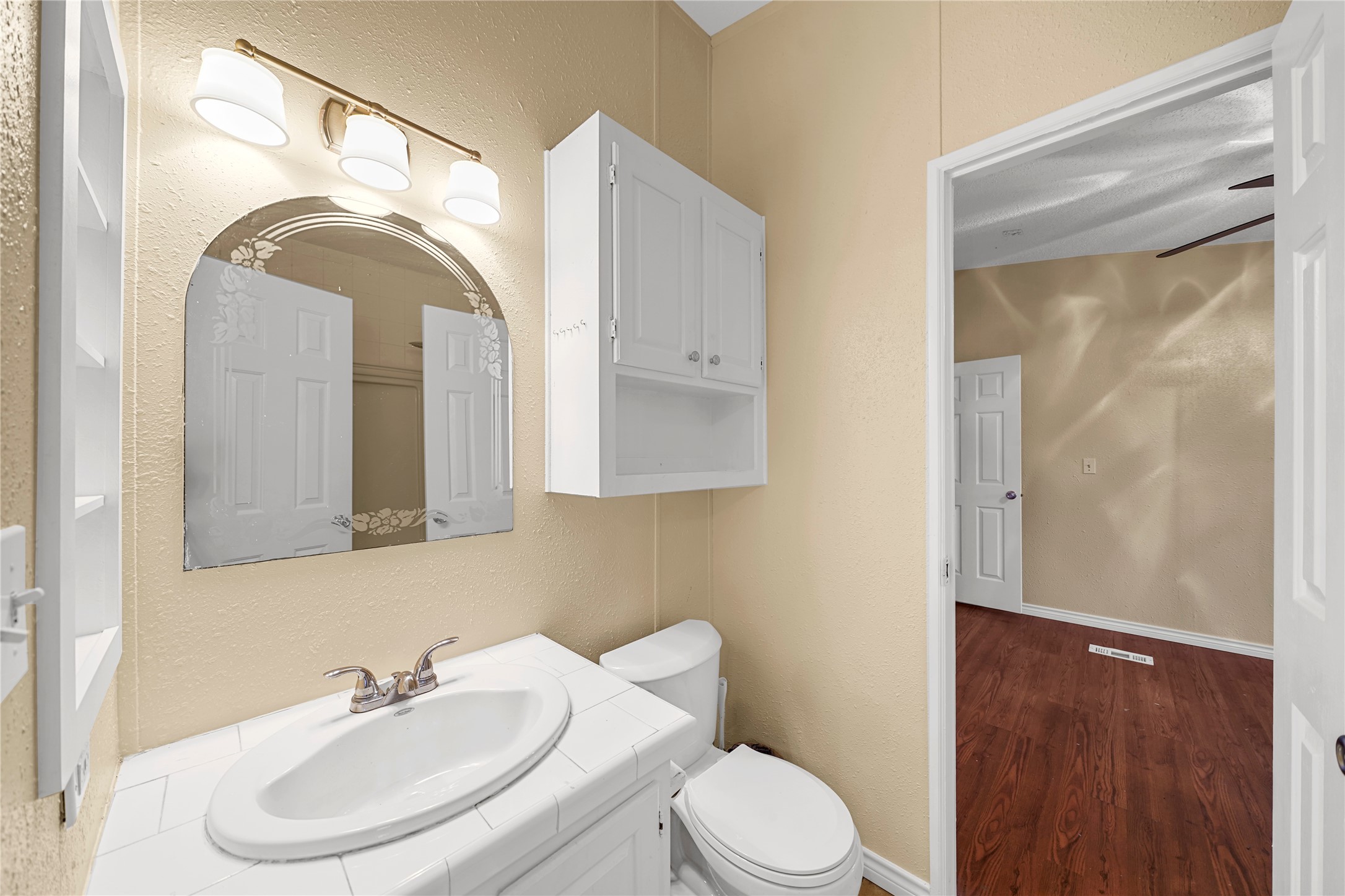19645 Nordt Road Damon, TX 77430 - Photo 20 of 50 a bathroom with a toilet a sink and mirror