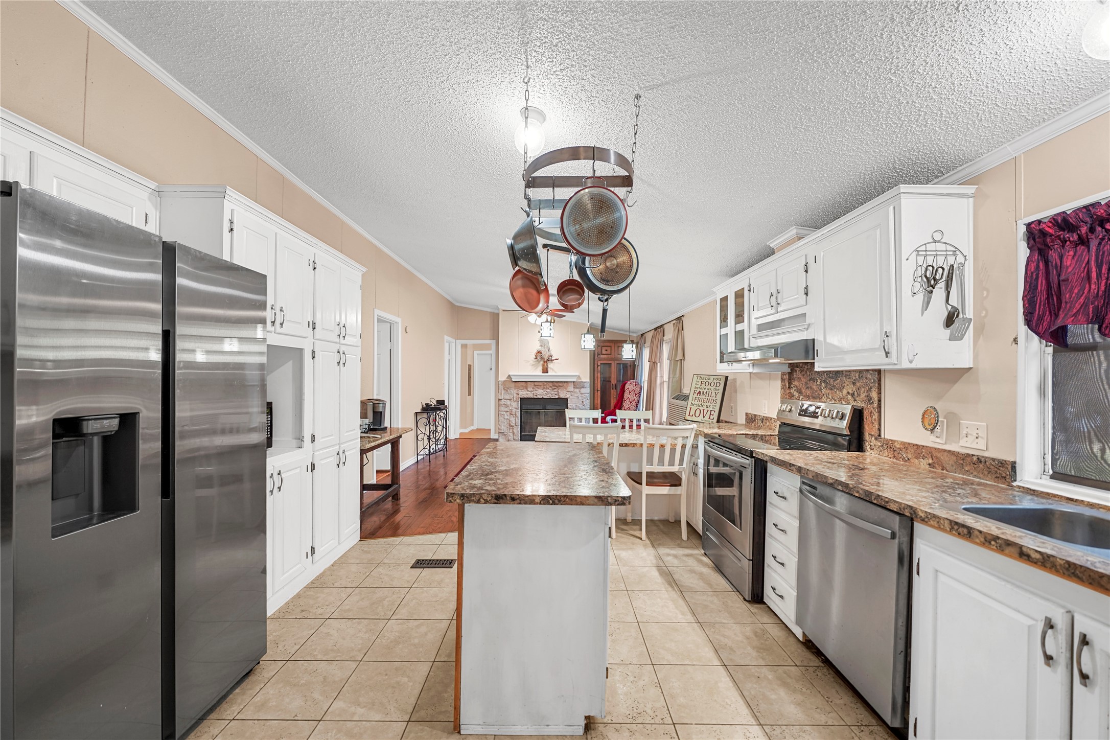 19645 Nordt Road Damon, TX 77430 - Photo 10 of 50 a kitchen with stainless steel appliances granite countertop a stove refrigerator and cabinets