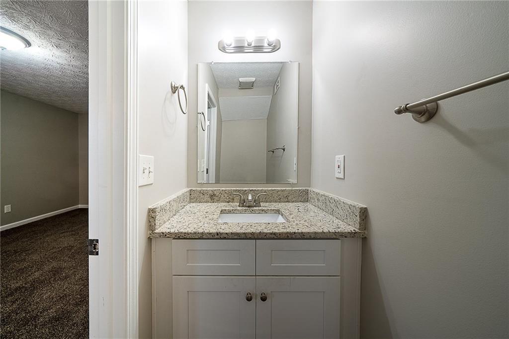 2183 Ramblewood Circle Decatur, GA 30035 - Photo 24 of 37 a bathroom with a granite countertop sink and a mirror