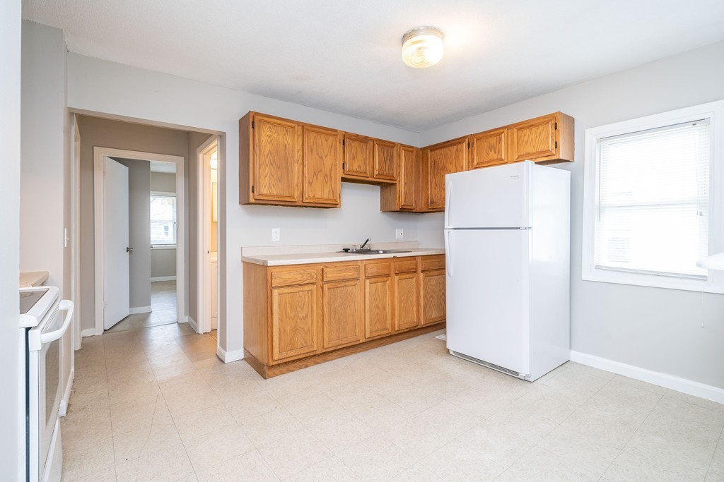 16 Collins Street Springfield, MA 01109 - Photo 1 of 17 a kitchen with a refrigerator a stove a microwave a sink and cabinets