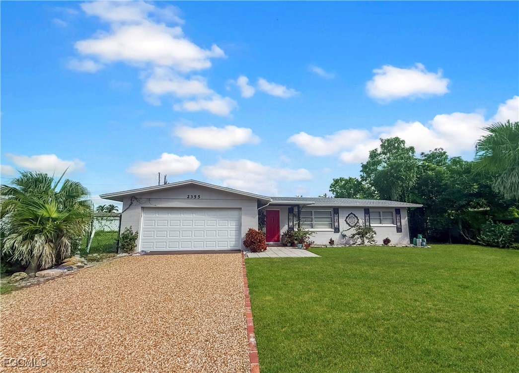 a front view of house with yard and green space