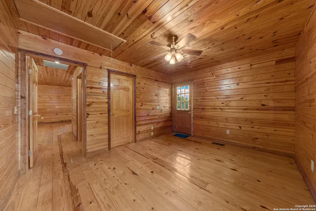 a view of empty room with wooden floor