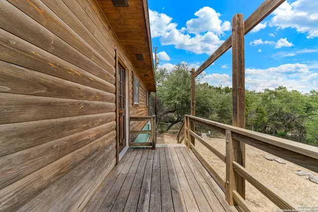 a view of balcony with wooden floor and fence