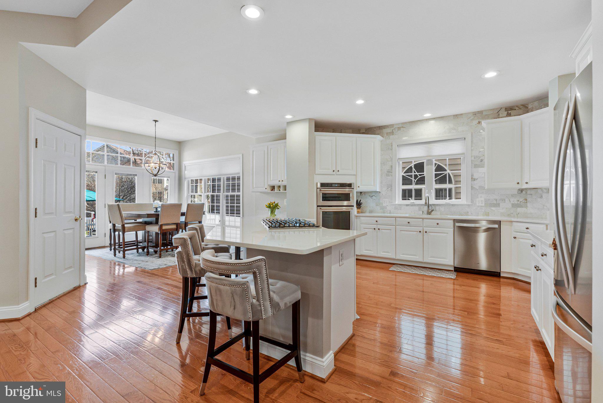 9183 Topaz Street Fairfax, VA 22031 - Photo 18 of 67 a living room with stainless steel appliances kitchen island granite countertop furniture wooden floor and a kitchen view
