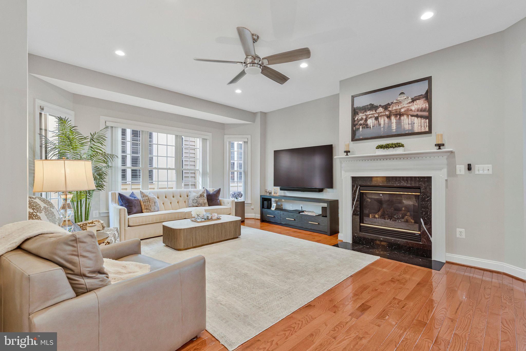9183 Topaz Street Fairfax, VA 22031 - Photo 21 of 67 a living room with furniture a fireplace and a flat screen tv
