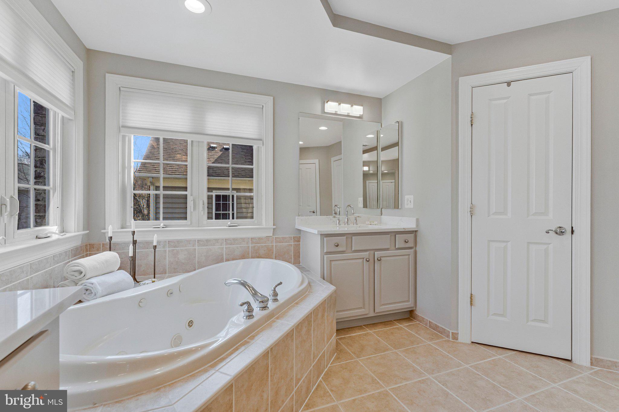 9183 Topaz Street Fairfax, VA 22031 - Photo 34 of 67 a bathroom with a granite countertop tub sink shower and mirror