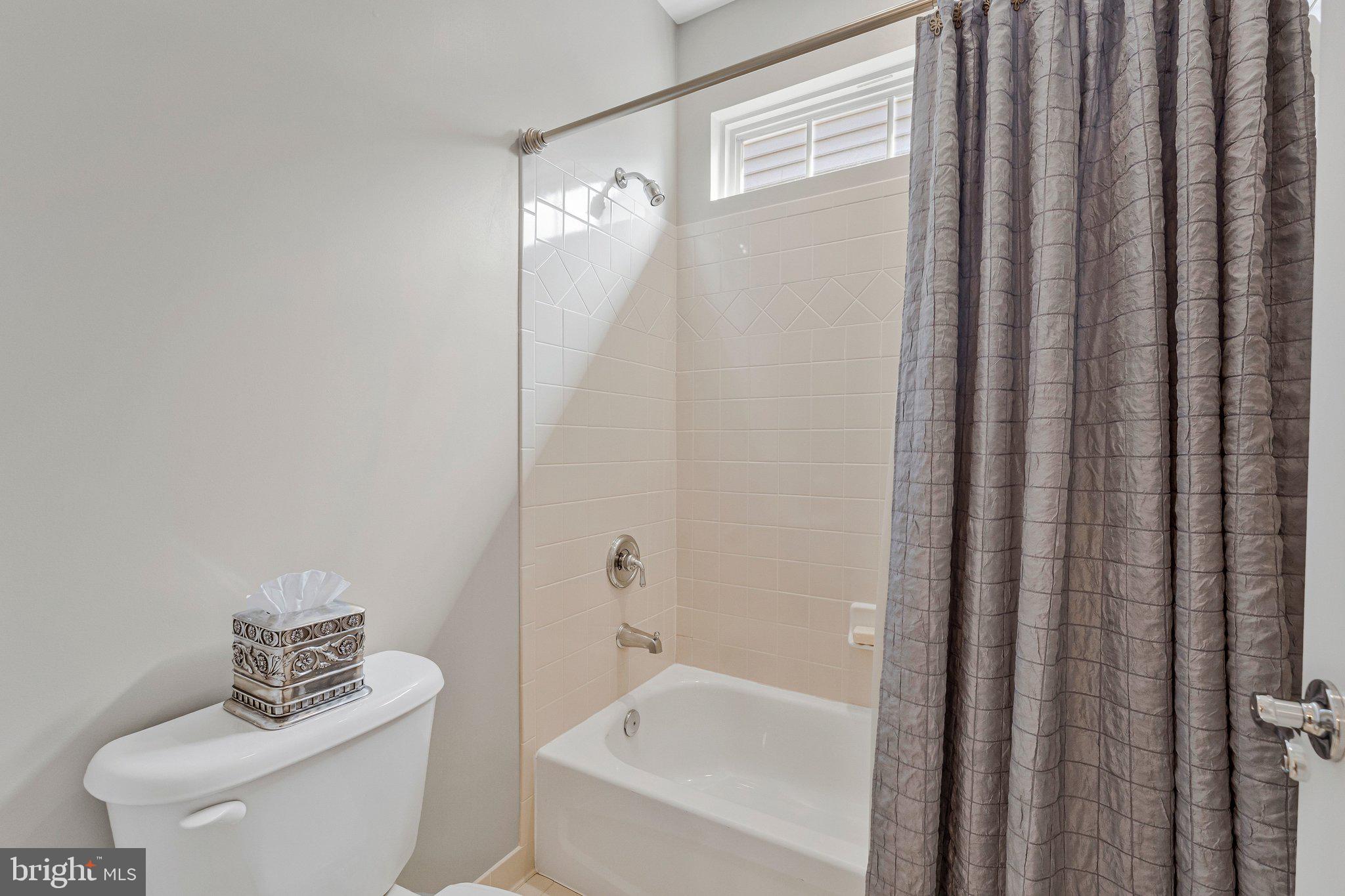 9183 Topaz Street Fairfax, VA 22031 - Photo 42 of 67 a white toilet sitting next to a bath tub