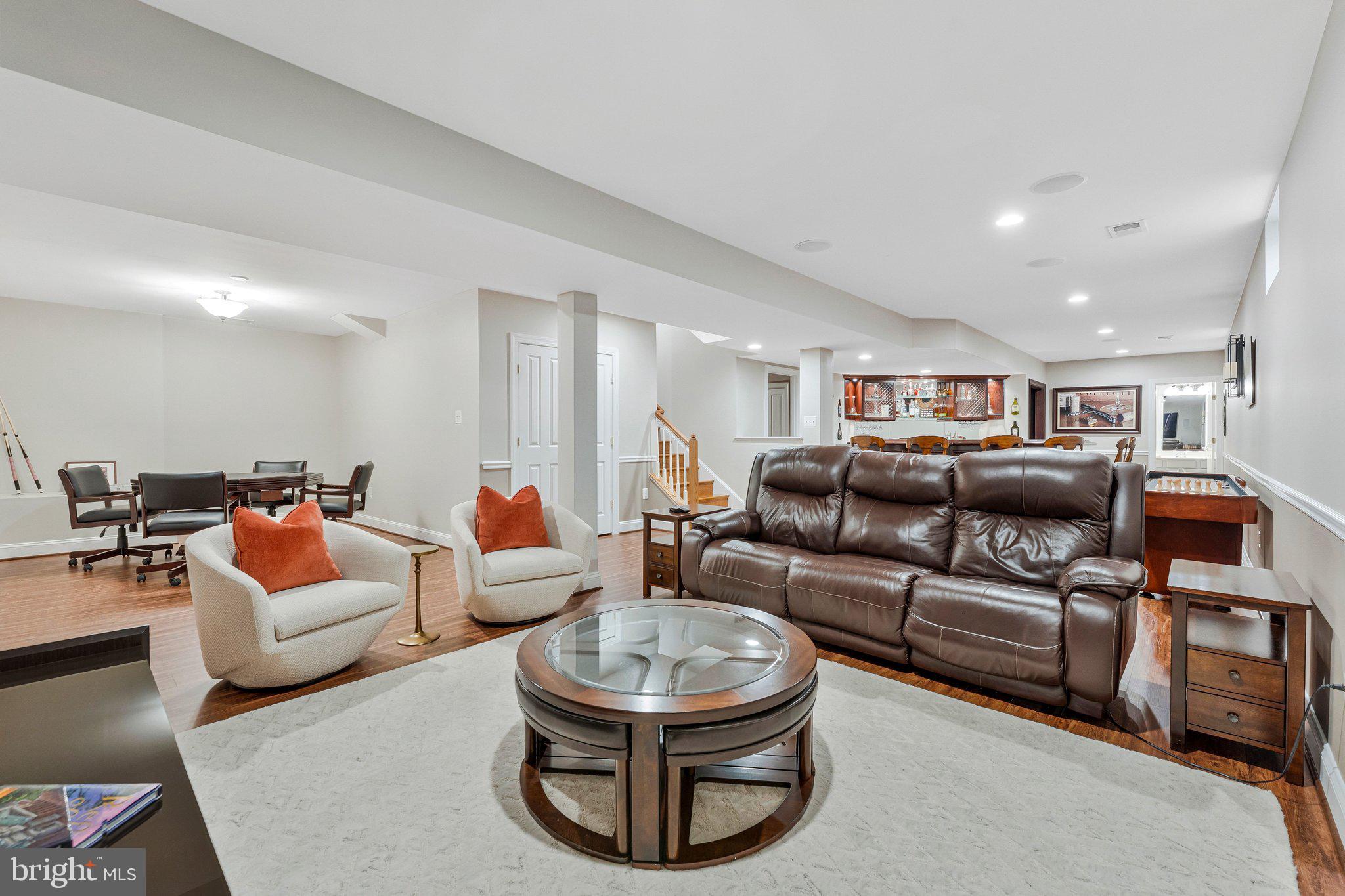 9183 Topaz Street Fairfax, VA 22031 - Photo 51 of 67 a living room with furniture a glass table and chairs