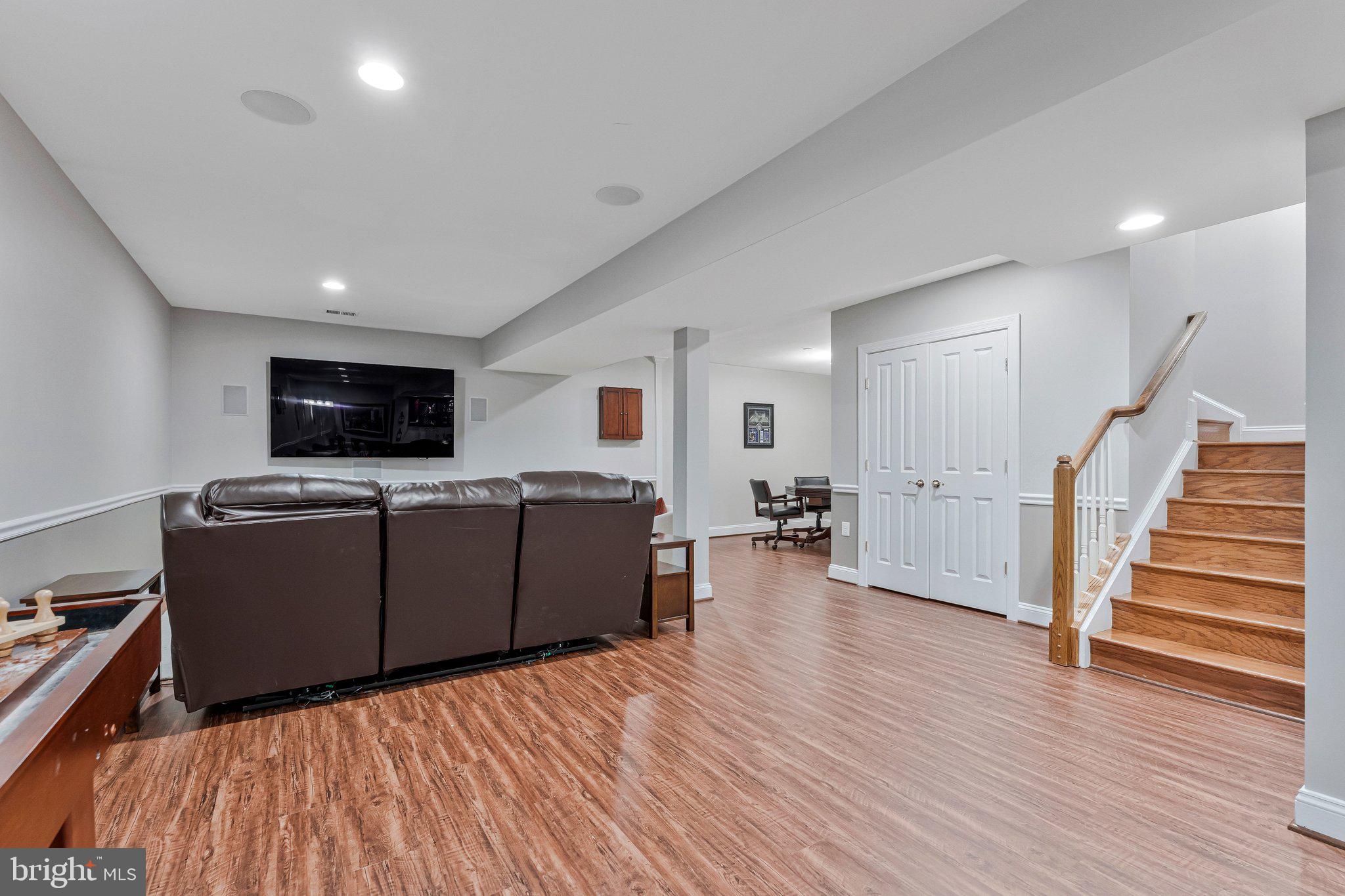 9183 Topaz Street Fairfax, VA 22031 - Photo 52 of 67 a living room with furniture and a flat screen tv