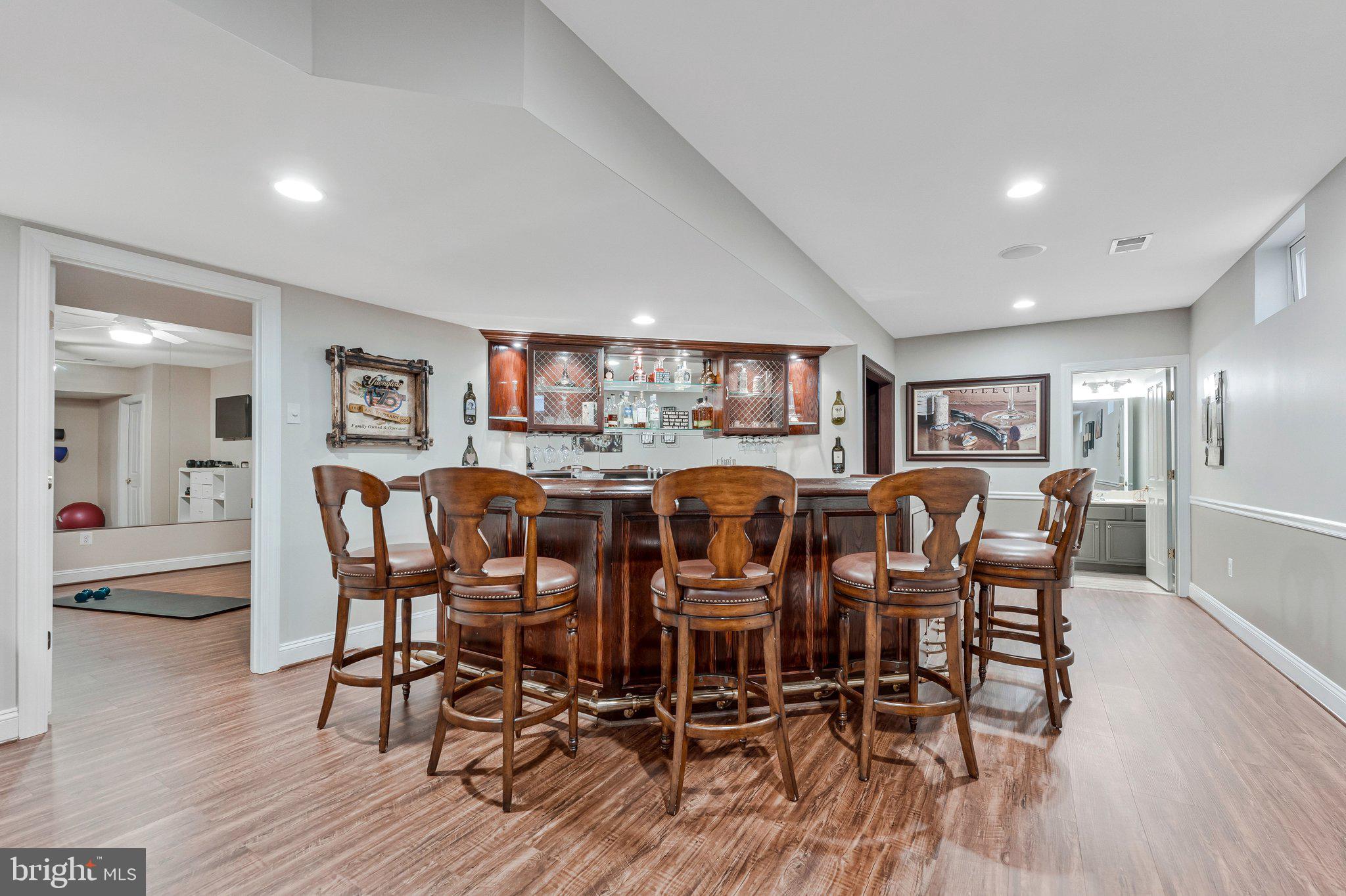 9183 Topaz Street Fairfax, VA 22031 - Photo 53 of 67 a view of a dining room and livingroom with furniture wooden floor a rug a painting