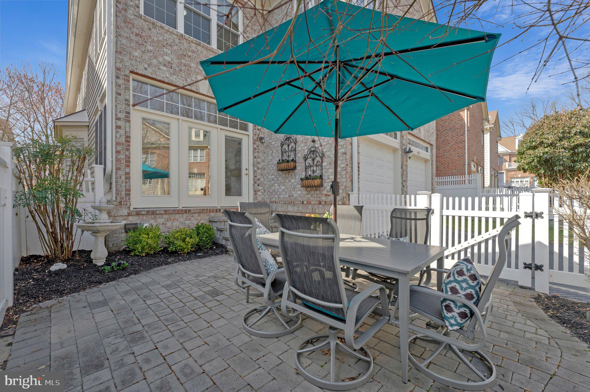 9183 Topaz Street Fairfax, VA 22031 - Photo 62 of 67 a view of a patio with table and chairs under an umbrella