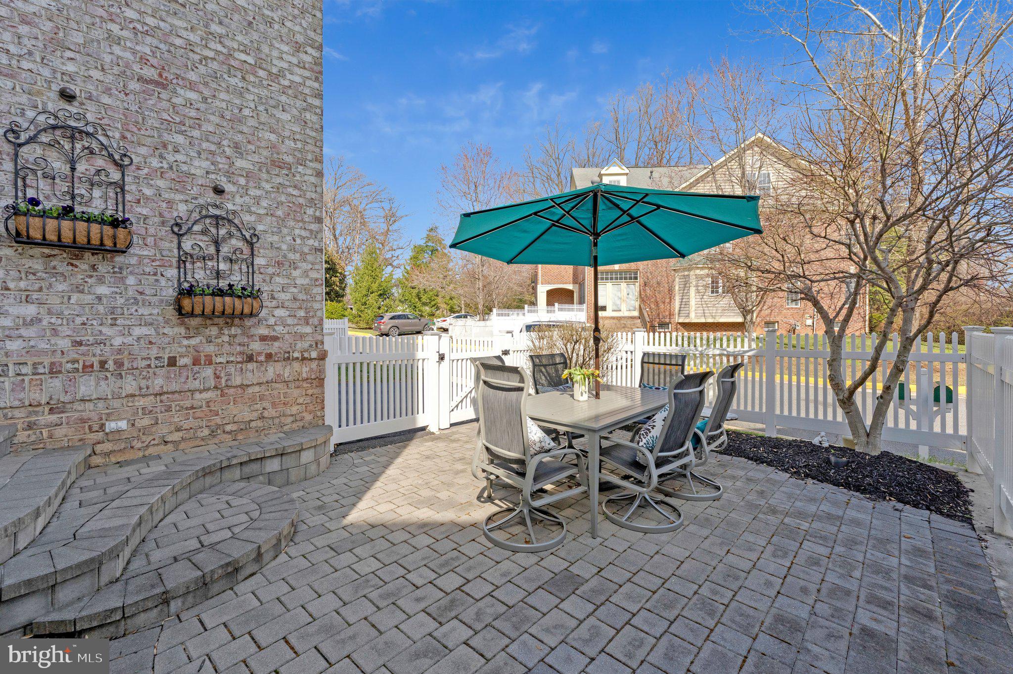 9183 Topaz Street Fairfax, VA 22031 - Photo 63 of 67 a view of a roof deck with table and chairs under an umbrella