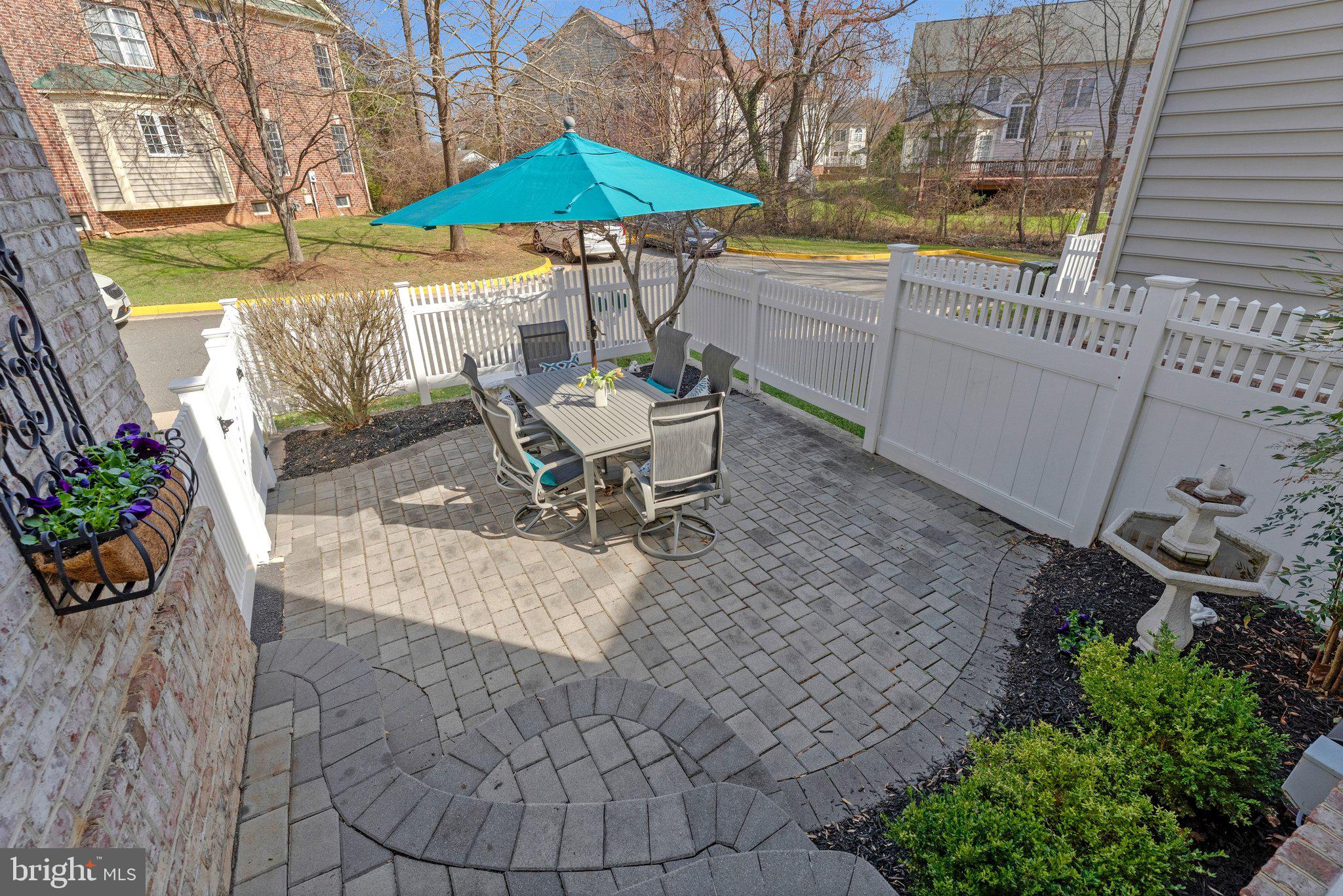 9183 Topaz Street Fairfax, VA 22031 - Photo 64 of 67 a view of a patio with a table and chairs under an umbrella