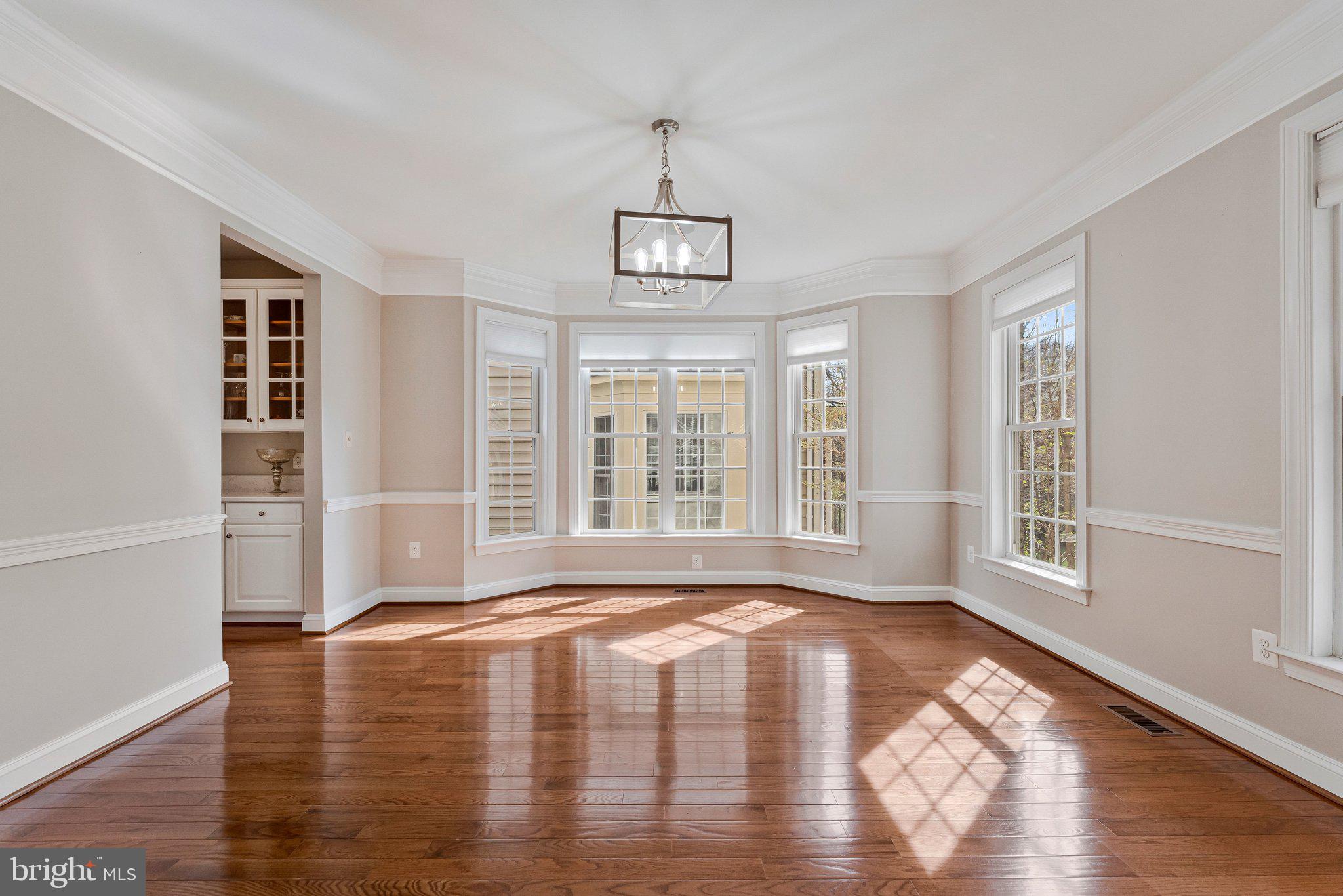 9183 Topaz Street Fairfax, VA 22031 - Photo 7 of 67 a view of an empty room with wooden floor and a window