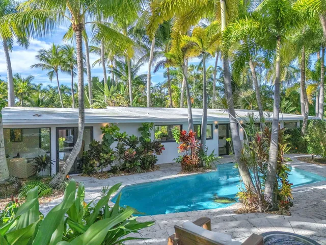a kitchen with a sink and large windows